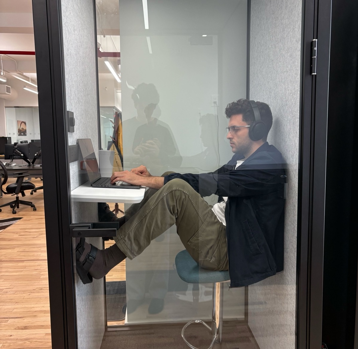 Bongi taking a meeting in the phone booth - classic position